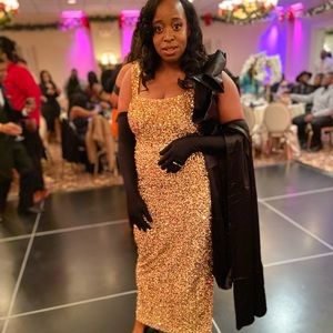 Gold sequins dress with long black gloves and black arm wrap/sash